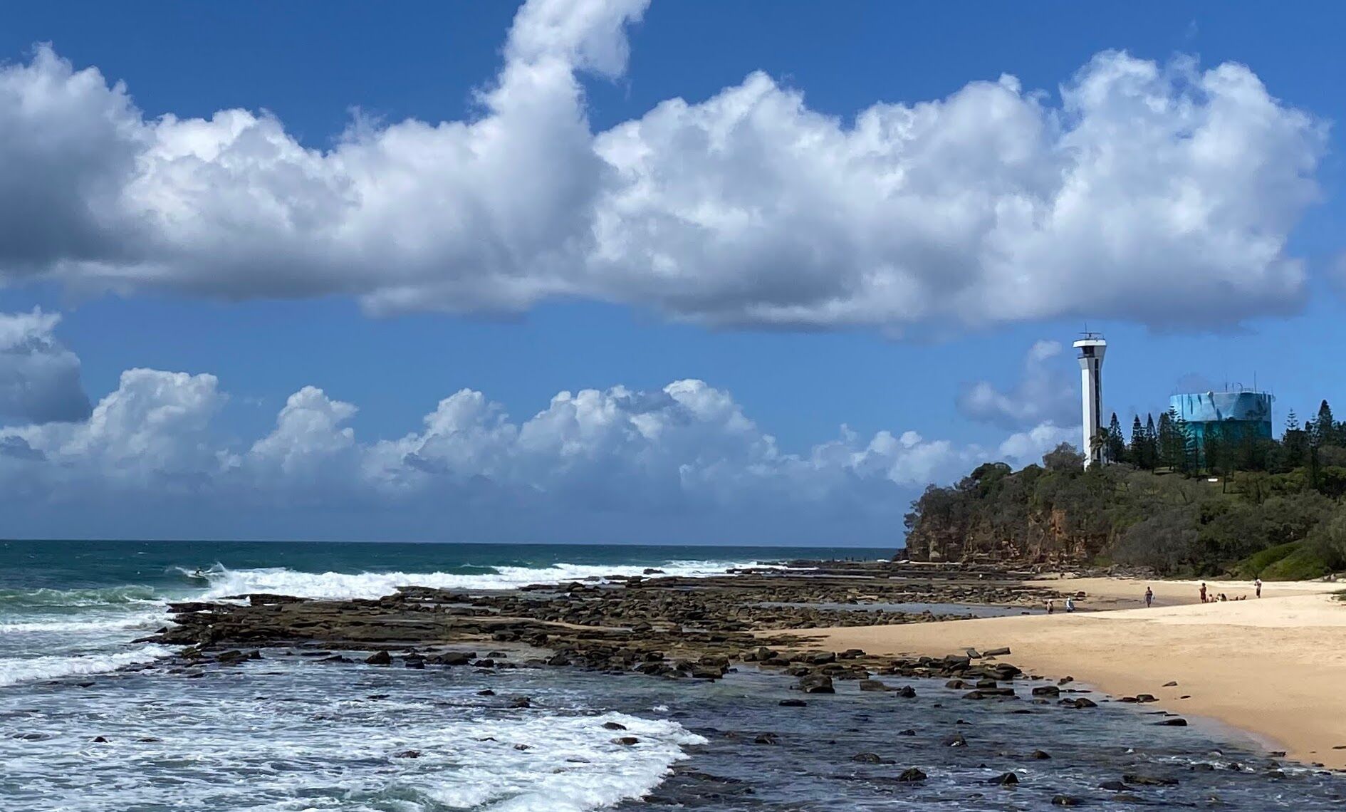 Point Cartwright lighthouse and rocky shoreline at Buddina