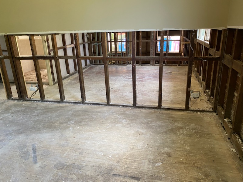 Wall linings removed to the timber frame, floor cleaned and ready for carpentry and relining